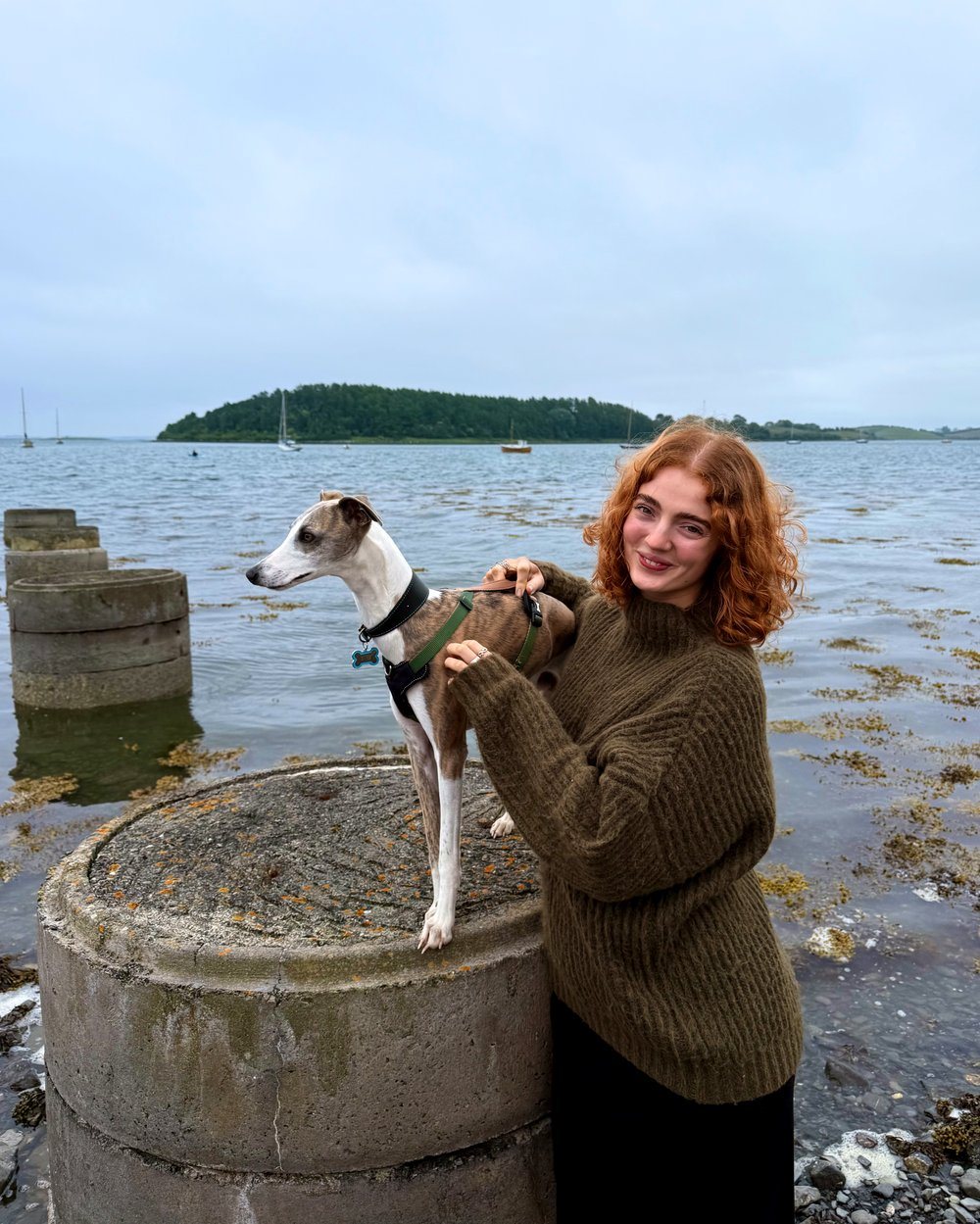 Bethy with Blue the whippet by the water in Northern Ireland